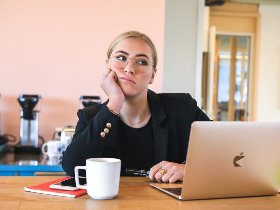 woman in black long sleeve shirt using macbook