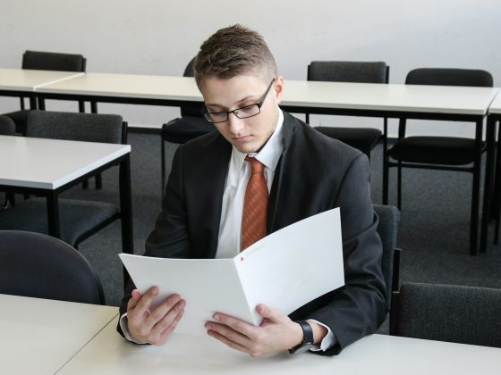 man holding folder in empty room