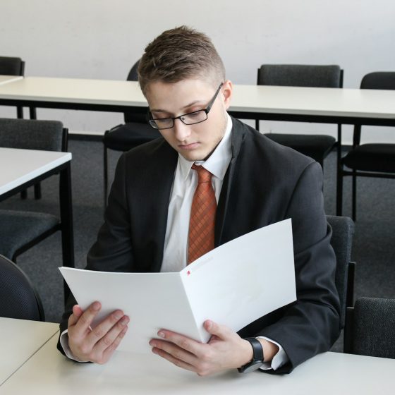 man holding folder in empty room