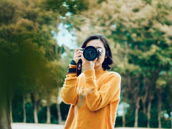 woman holding DSLR camera