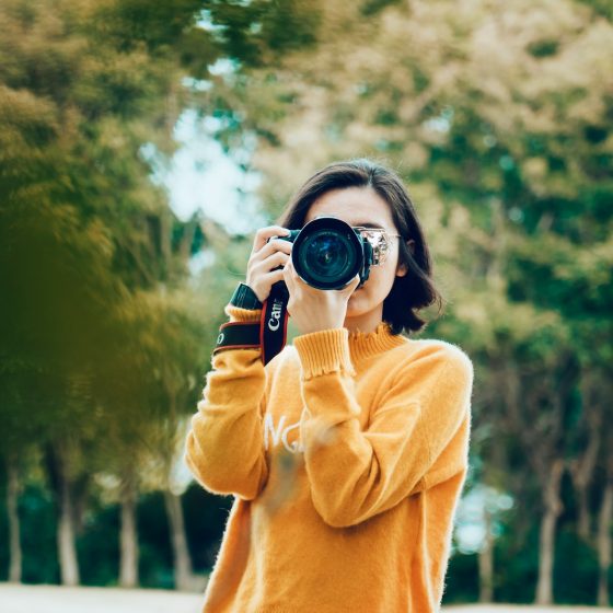 woman holding DSLR camera